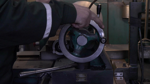 Worker Operates A Old-time Metal China Grinding China Machine. Free HD Video Stock Footage